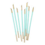 Set of light blue and gold makeup brushes on a white background