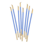 Set of blue and gold candles on a white background