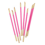 Set of pink and gold pens on a white background