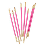 Set of pink and gold pens on a white background