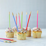 Cupcakes with colorful candles on a light background