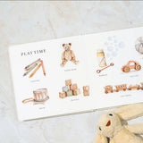 Children's book with illustrations of toys on a marble surface
