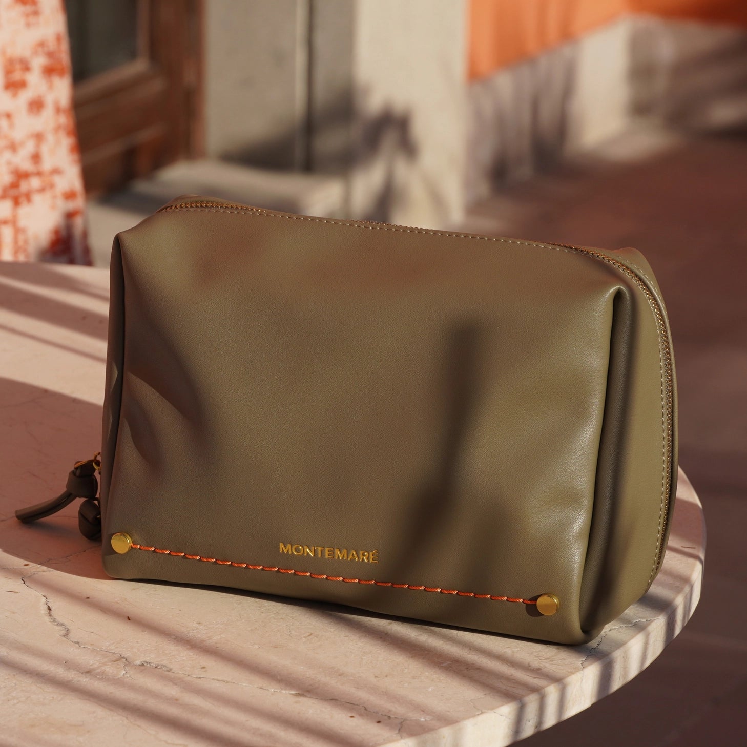 Montemare Roma Standing Toiletry Case in Olive on a marble surface.