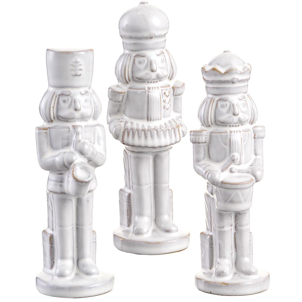 Three white ceramic nutcrackers on a white background