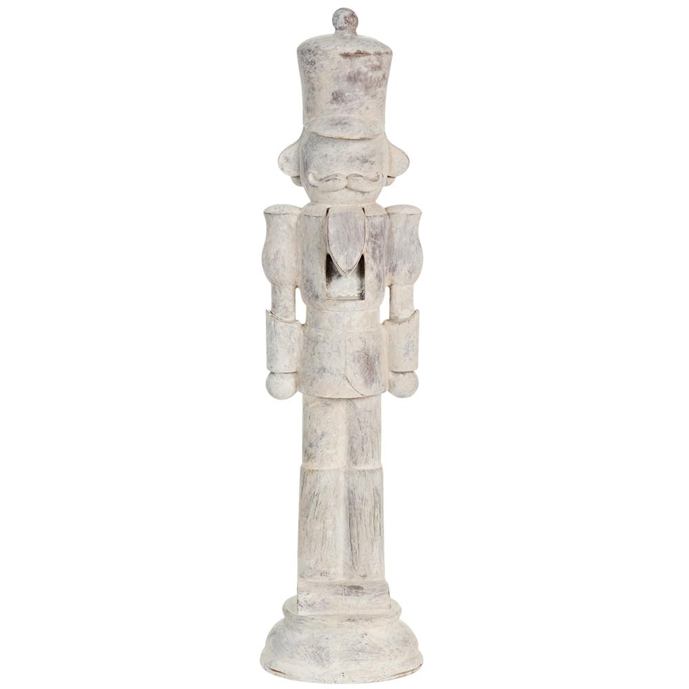 Decorative wooden nutcracker figure with a white distressed finish on a white background