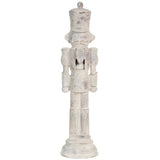 Decorative wooden nutcracker figure with a white distressed finish on a white background