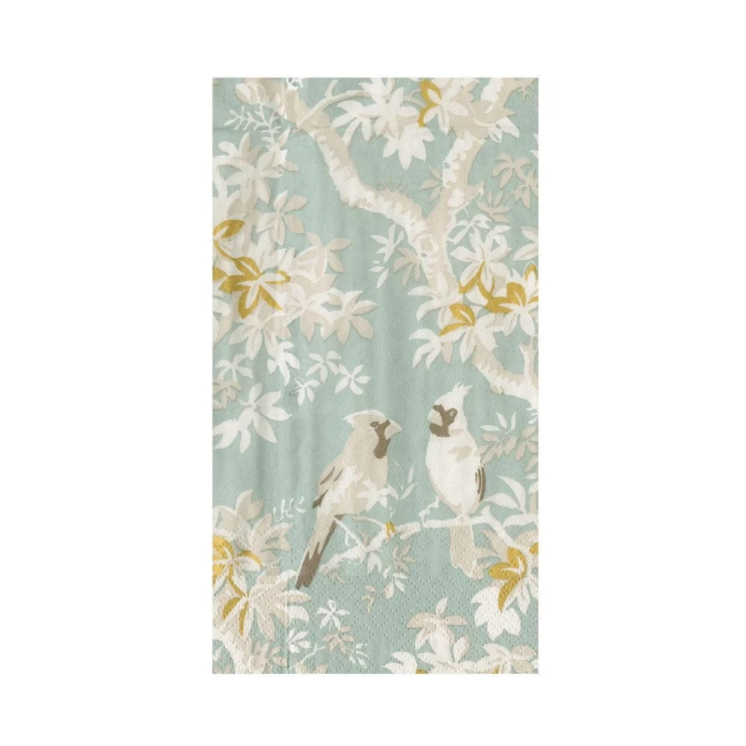 A rectangular paper guest towel featuring a pattern of two birds perched on branches with white blossoms against a soft sage green background.
