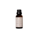 Gold and white L'avant laundry oil bottle with brand name on a beige background