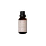 Gold and white L'avant laundry oil bottle with brand name on a beige background