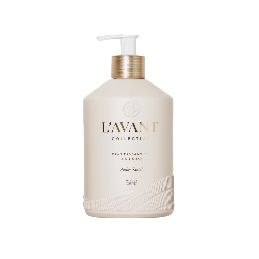 L'Avant Collective Andrea Santeal high performing dish soap in a matte cream-colored pump bottle with a metallic gold collar and white pump dispenser, set against a plain white background.
