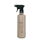 A bottle of L'Avant Collective Multipurpose  Cleaner in Amber Shade, featuring a beige bottle and a black spray nozzle, set against a plain white background.
