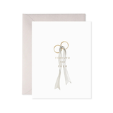 Gold ring with a white ribbon and 'Forever and Ever' text on a light gray background