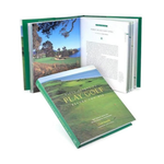 Golf-themed book with a scenic cover and open pages showing text and images.