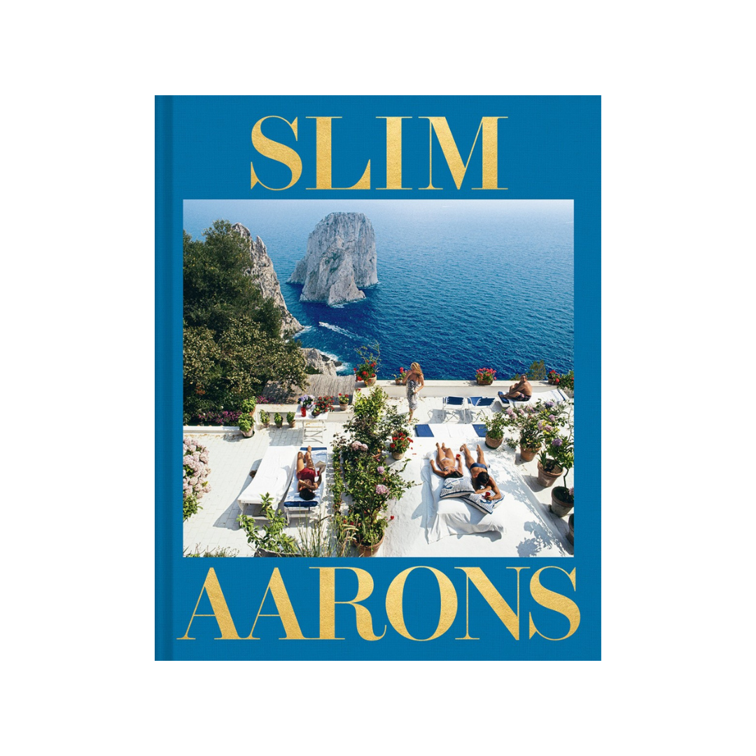 Book cover with 'Slim Aarons' text and scenic image of a coastal location.