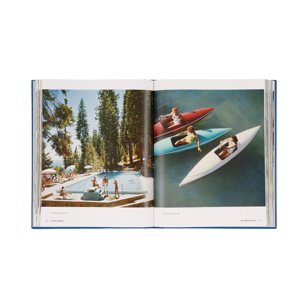 Open book showing a scene of people in kayaks and at a pool with trees in the background