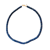 Blue beaded necklace on a white background