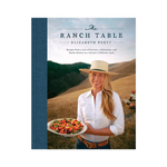 Book cover of 'The Ranch Table' with a woman holding a plate of food in a scenic setting.