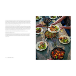 The Ranch Table Cookbook recipe People sharing a meal at a wooden table with various dishes and drinks.