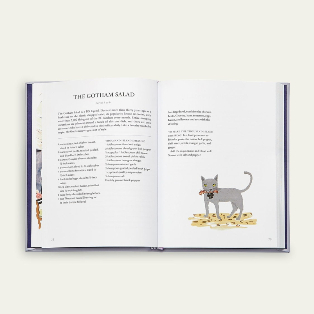 Open  Bergdorf Goodman Cookbook with a cat illustration on a white background