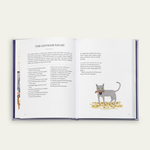 Open  Bergdorf Goodman Cookbook with a cat illustration on a white background