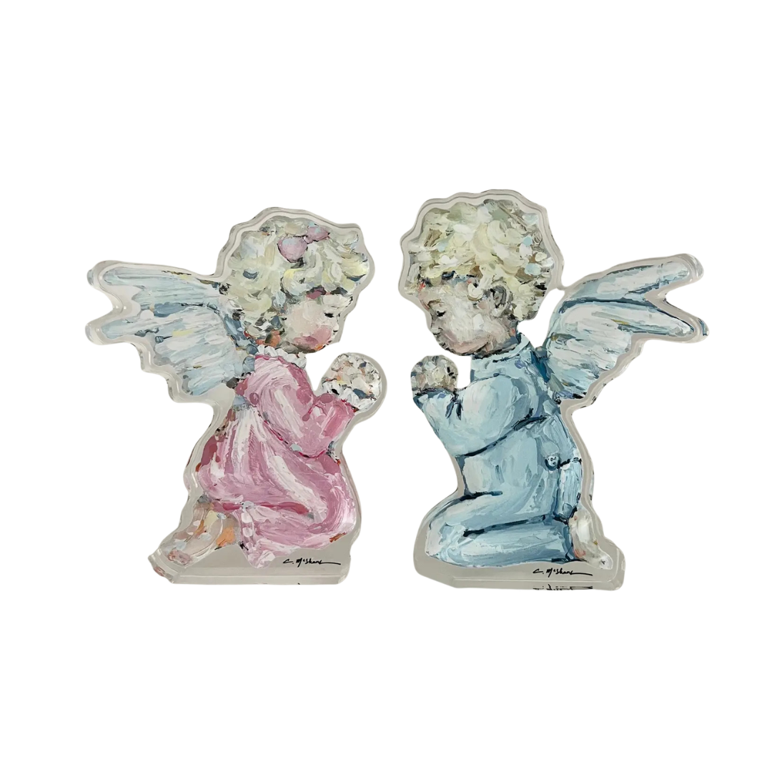 Two angel figurines, one in pink and one in blue, on a white background.