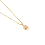 A delicate gold chain necklace featuring a small, irregular-shaped gold pendant with a smooth, pale pink inlay, shown against a plain white background.