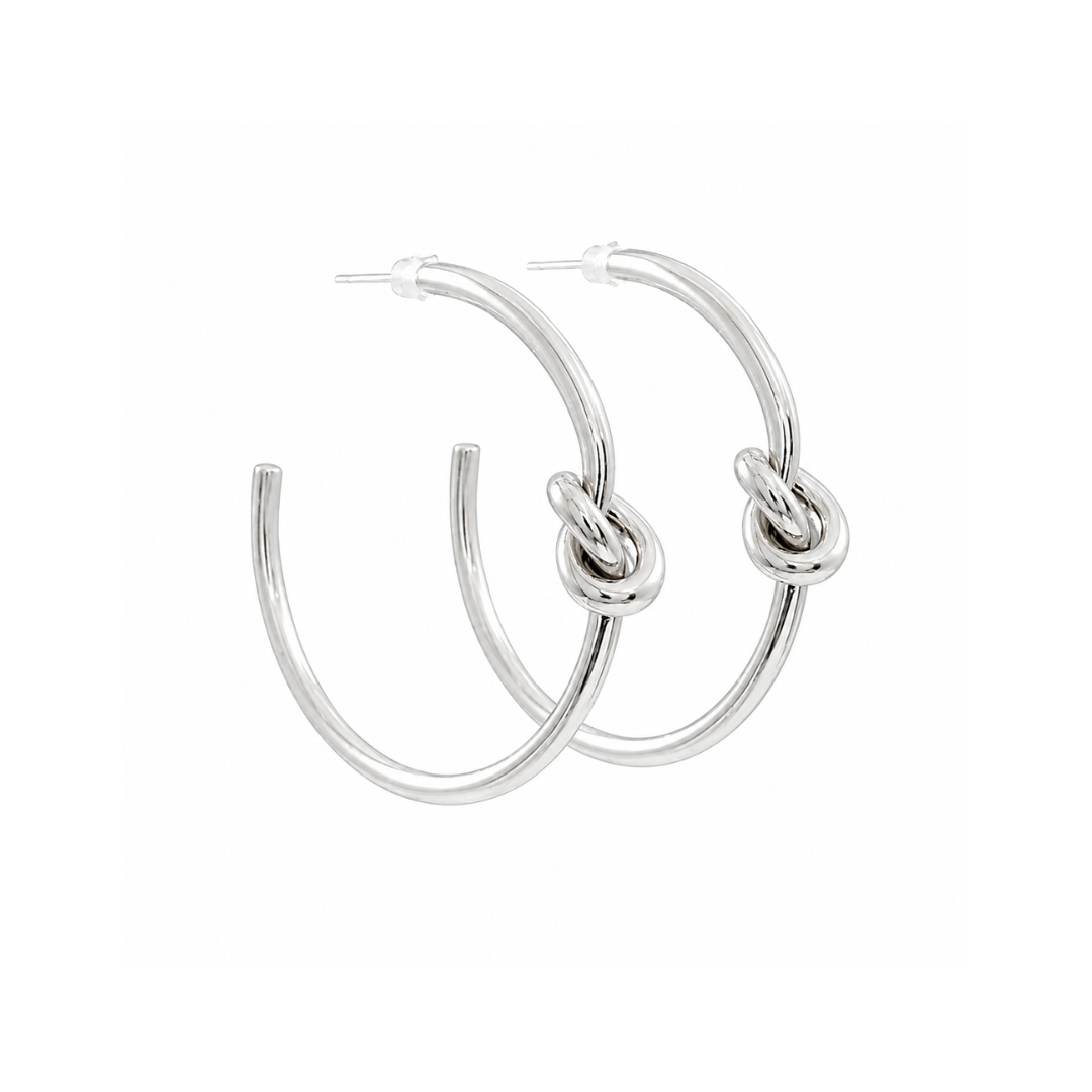 A pair of polished silver hoop earrings with a central knotted detail, shown against a plain white background.