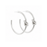 A pair of polished silver hoop earrings with a central knotted detail, shown against a plain white background.