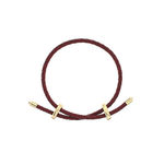A dark burgundy braided cord bracelet with gold-toned toggle sliders, displayed on a clean white background.