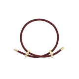A dark burgundy braided cord bracelet with gold-toned toggle sliders, displayed on a clean white background.