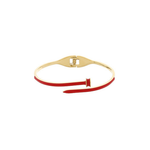 A gold-plated bangle bracelet with a red enamel wrap and a small red accent tab, shown on a plain white background.