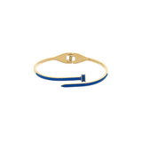 A gold-plated bangle bracelet with a vibrant blue enamel inlay, shown on a plain white background.