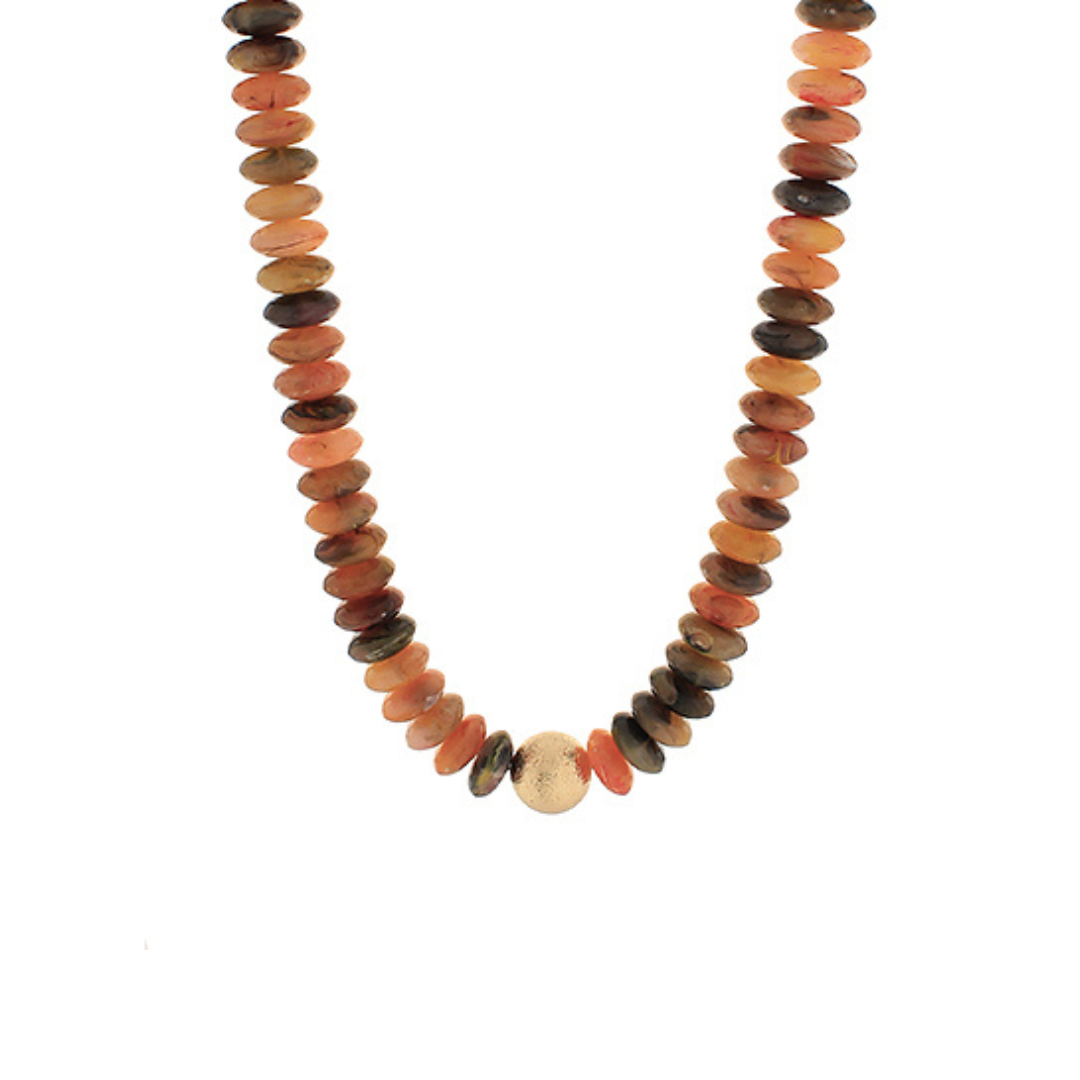 A beaded necklace made of flat, polished oval stones in earthy terracotta, brown, and orange tones, with a single round light beige bead at the center, shown on a plain white background.