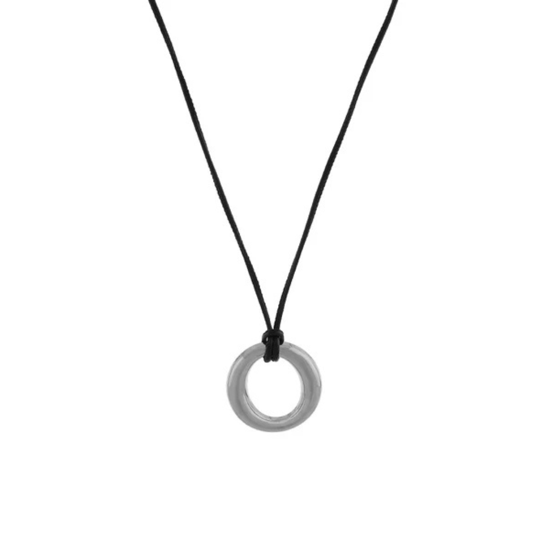 A minimalist silver ring pendant necklace on a thin black cord, shown against a plain white background.