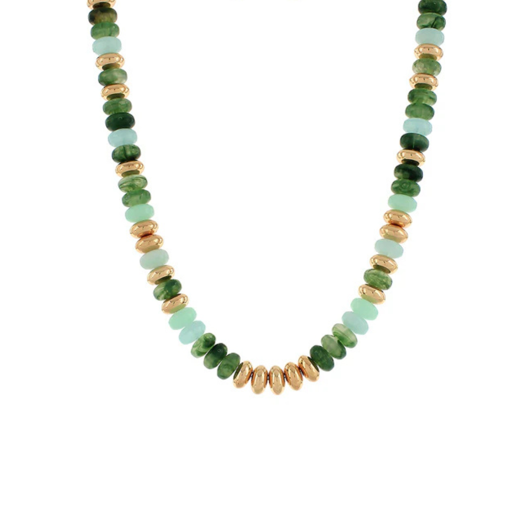 A beaded necklace featuring faceted green stone beads and textured gold spacer beads, arranged in a U-shape on a plain white background.