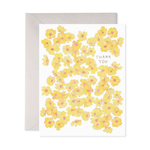 Greeting card with yellow floral pattern and envelope on a white background