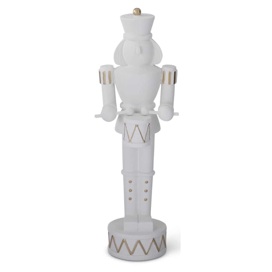 white resin nutcracker, gold detail, holding drum