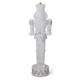 white resin nutcracker, gold detail, holding drum