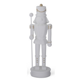 white resin nutcracker, gold detail, holding white staff