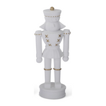 white resin nutcracker, gold detail