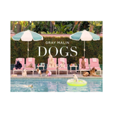 Book cover of 'DOGS' by Gray Malin featuring dogs around a pool with umbrellas.