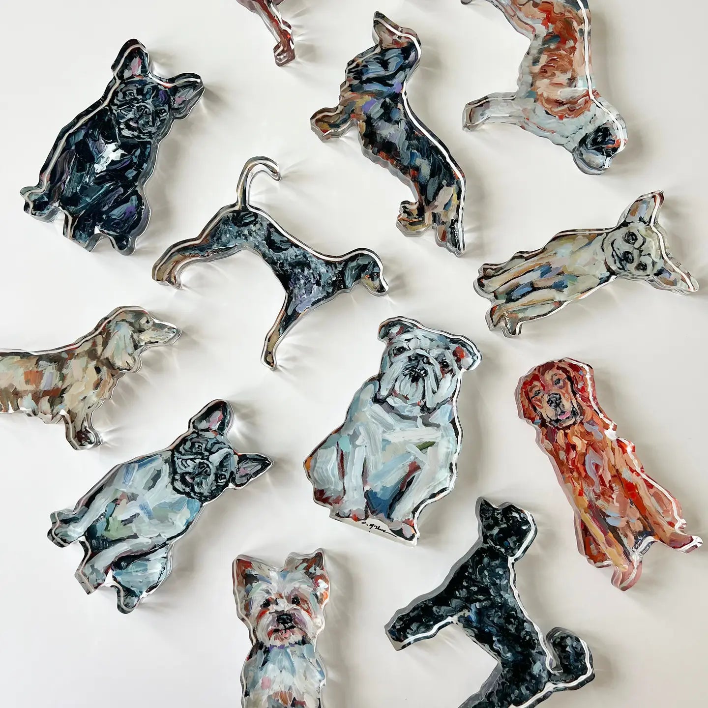 Collection of ceramic dog figurines in various poses on a white background