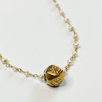 dainty gold and pearl necklace with hexagon pendant