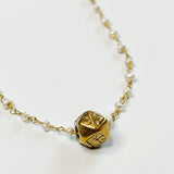 dainty gold and pearl necklace with hexagon pendant