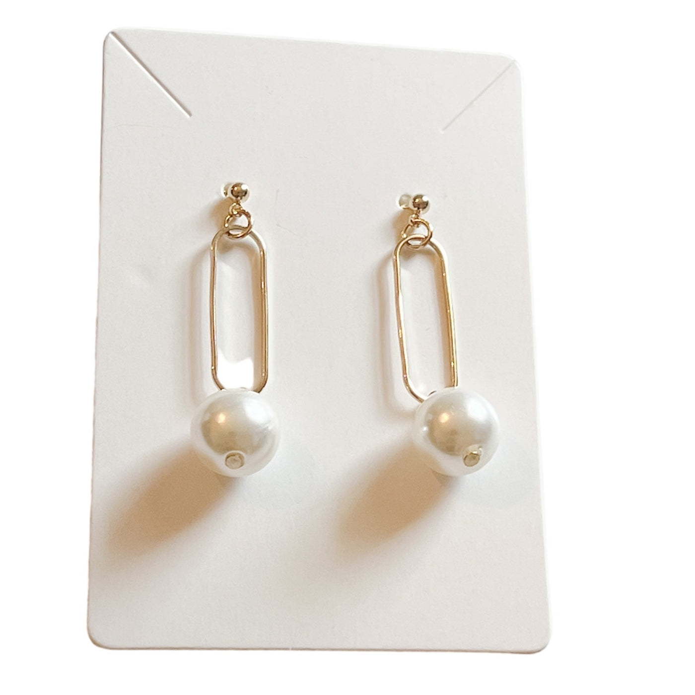 dangle gold design with an oval shape and small pearl charm