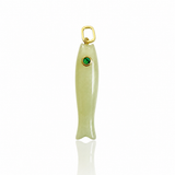 A fish-shaped pendant charm made of pale green stone with a small green gemstone for an eye and a gold-tone loop at the top, shown on a white background.
