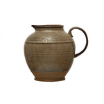 Brown ceramic pitcher on a white background