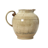 Beige ceramic pitcher on a white background