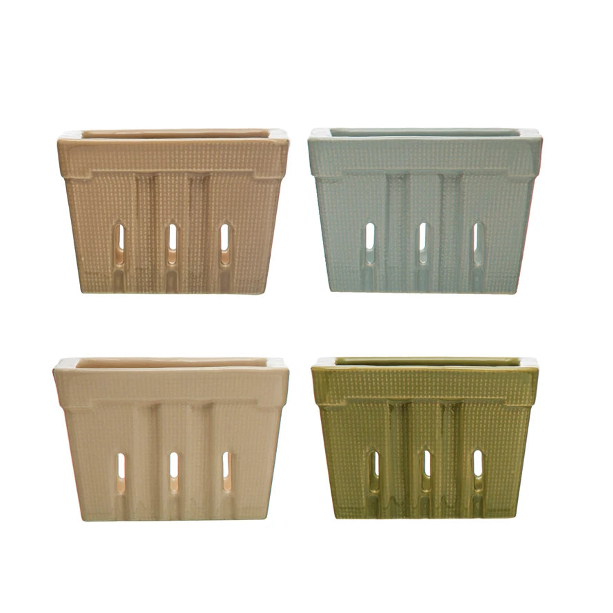 Four rectangular berry baskets in beige, green, and brown on a white background