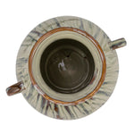 top view of hand-painted stoneware vase with twin handles and a reactive glaze of cream, green, and brown on a white background